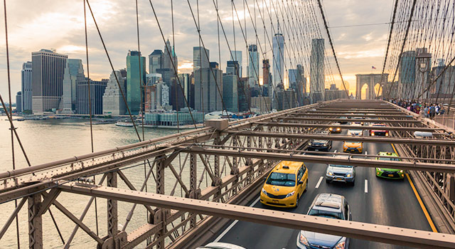 traffic driving away from New York City on Brooklyn Bridge