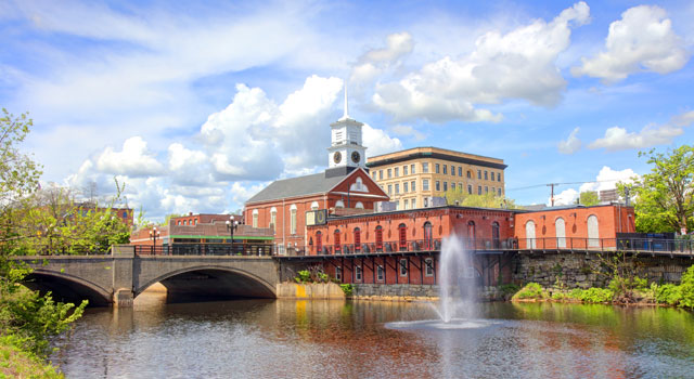 Bridge over a river with a town in the distance
