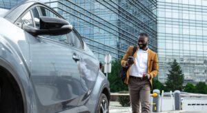 Businessman approaching his company car