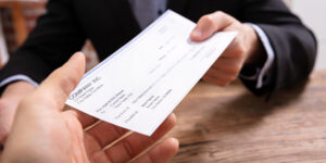 Someone receiving a home insurance check