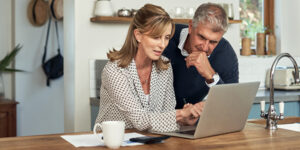 A couple looking at a home insurance quote on a laptop